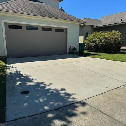 Same residential driveway fully pressure washed by Precision Wash Co., showing uniform clean concrete.