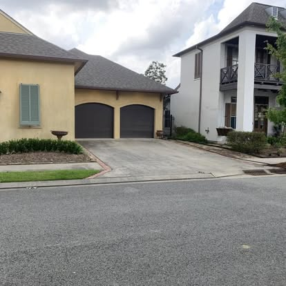 Louisiana home exterior with dirty siding, stained trim and grimy walkways before pressure washing service.